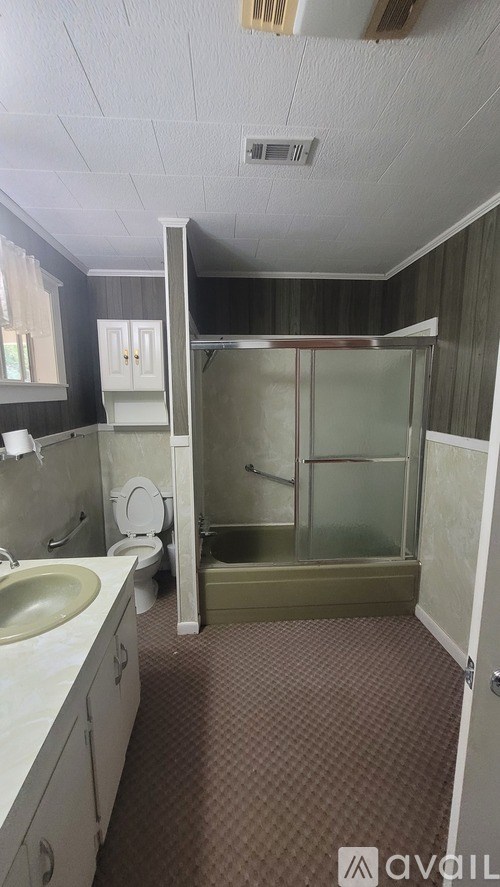A bathroom with a sink, toilet, and shower.