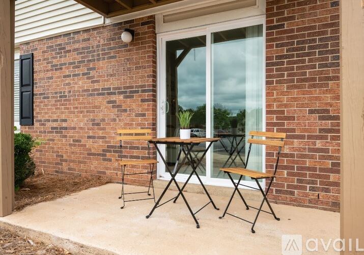 A patio with a table and chairs is available for use.