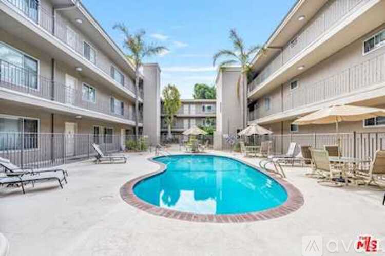 A swimming pool in a courtyard surrounded by apartment buildings.