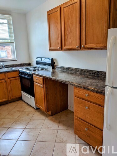 A kitchen with wooden cabinets and a white fridge.