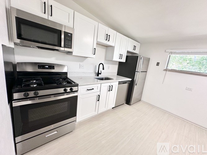 A kitchen with white cabinets and a stainless steel oven.