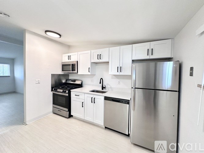 A kitchen with white cabinets and stainless steel appliances.