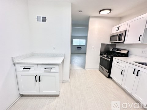 A kitchen with white cabinets and a countertop.