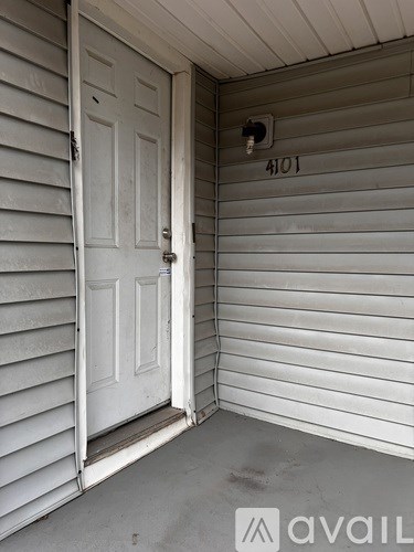 A white door with the number 4101 on the wall above it.