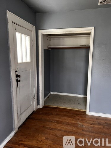 A room with a white door and a window.