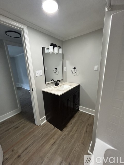 A bathroom with a vanity and a mirror.