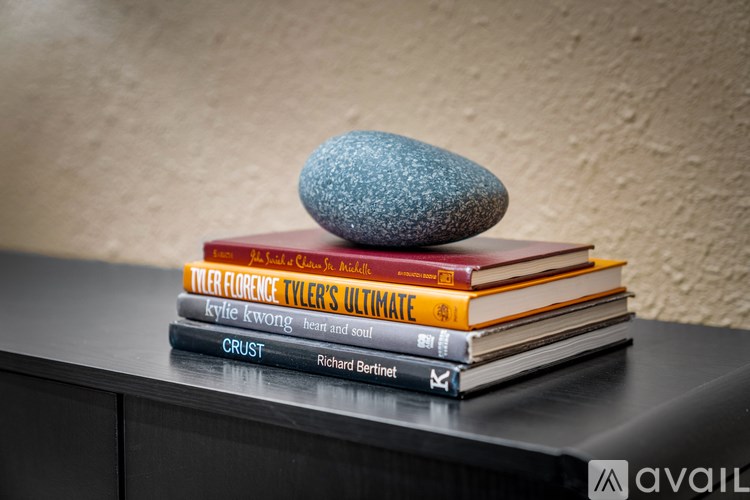 A stack of books with a smooth stone on top.