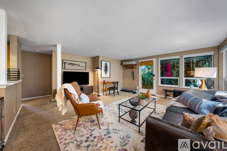 A living room with a brown couch, a chair, and a coffee table.