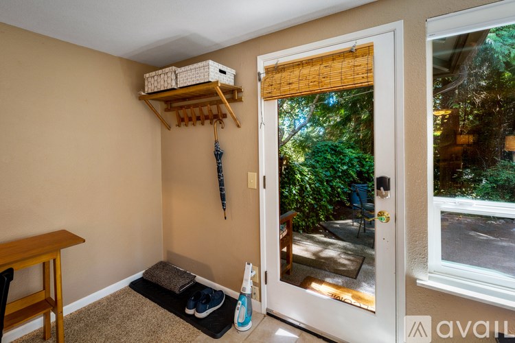 A room with a brown wall and a white door leading to a patio.