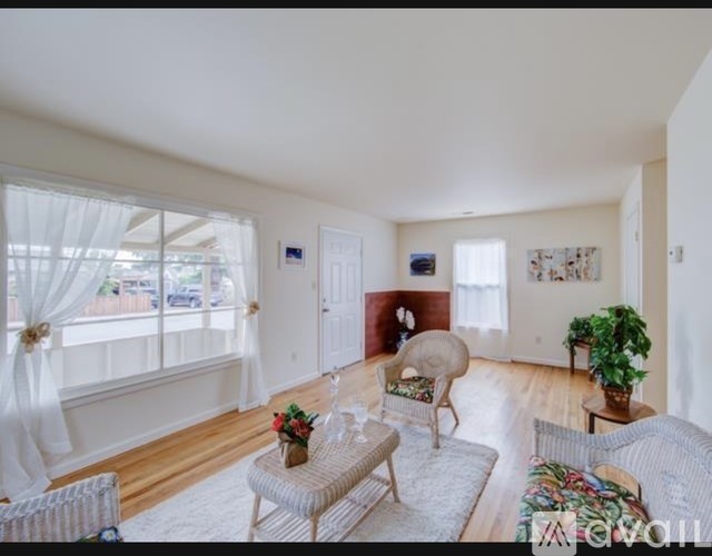 A living room with a sofa, chair, and table.