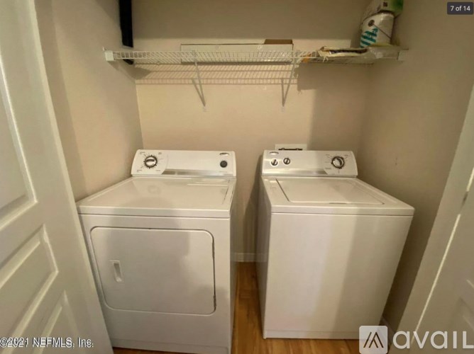 A small laundry room with a washer and dryer.