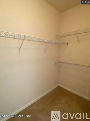 Empty room with white walls and a shelving unit.