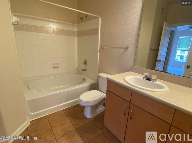 A bathroom with a toilet, sink, and bathtub.