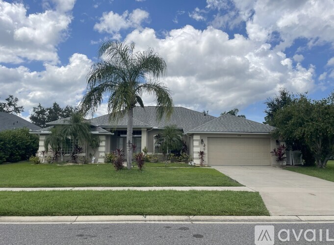 A house with a palm tree in front.