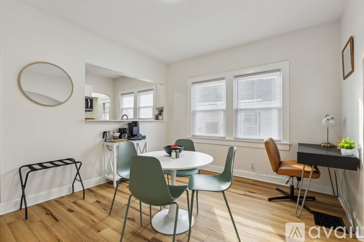 A living room with a dining table and chairs.