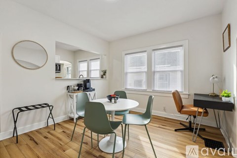 A living room with a dining table and chairs.