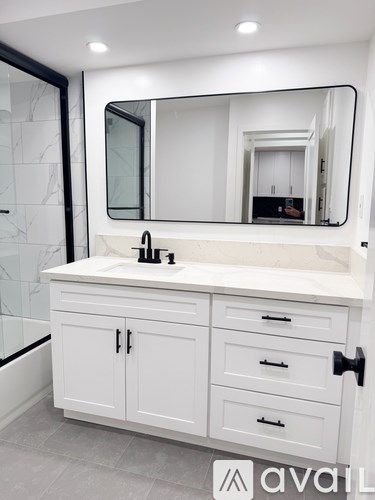 A bathroom vanity with a sink and a mirror.