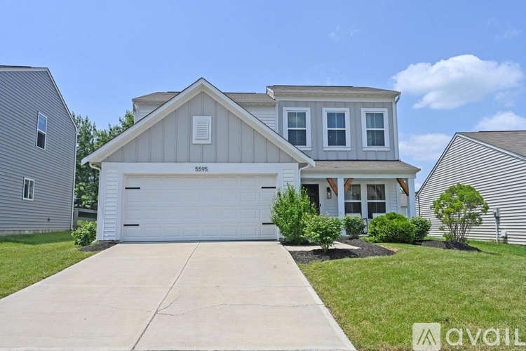 A two-story house with a garage is for sale.