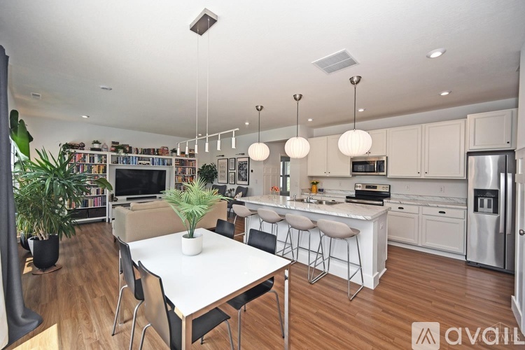 A modern kitchen with a dining table and chairs.