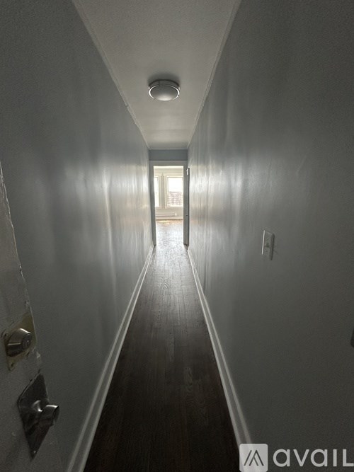 A long hallway with a light at the end.