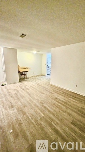 A room with white walls and a door on the left.
