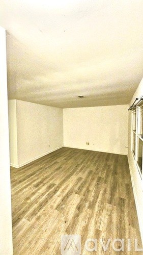 A kitchen with black cabinets and a white door.