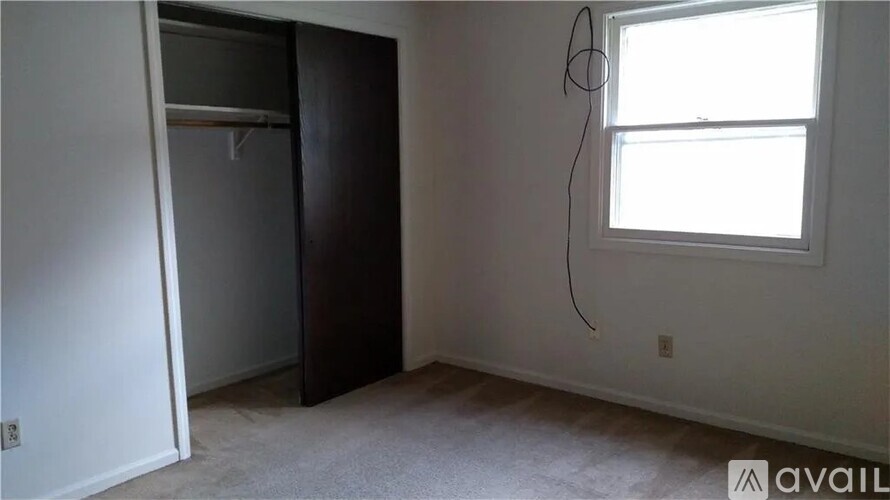 A room with a window and a door is available for rent.