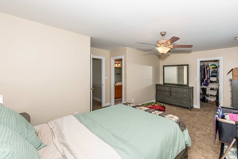 Bedroom with a bed, dresser, and mirror.