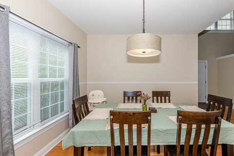A dining room with a table set for two.