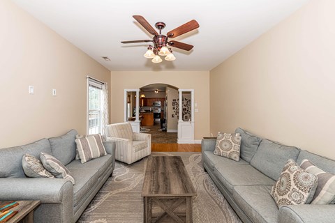 A living room with two grey couches and a wooden coffee table.