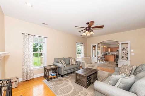 A living room with a grey couch and a wooden coffee table.