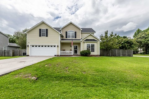 A house with a flag on the front porch.