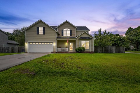 A house with a flag on the front porch is shown.