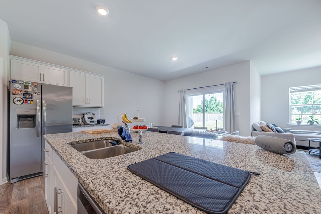 A kitchen with a granite countertop and a sink.