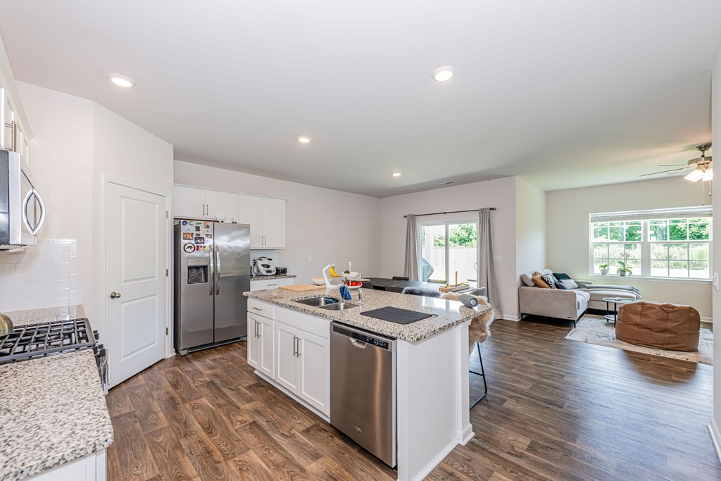 A kitchen with a refrigerator, stove, and oven.