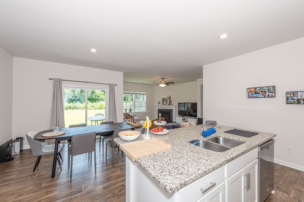 A kitchen with a dining table and chairs is set up.