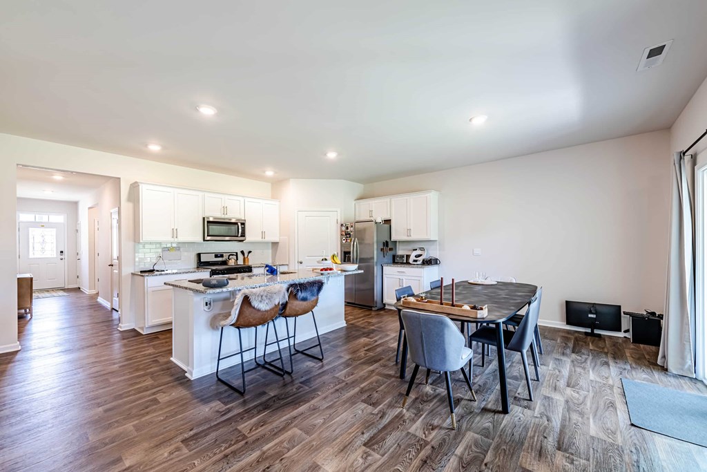 A modern kitchen with a dining table and chairs.