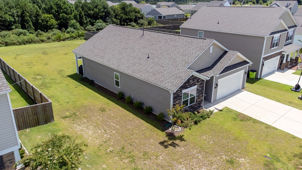A house with a grey roof and a white garage door.