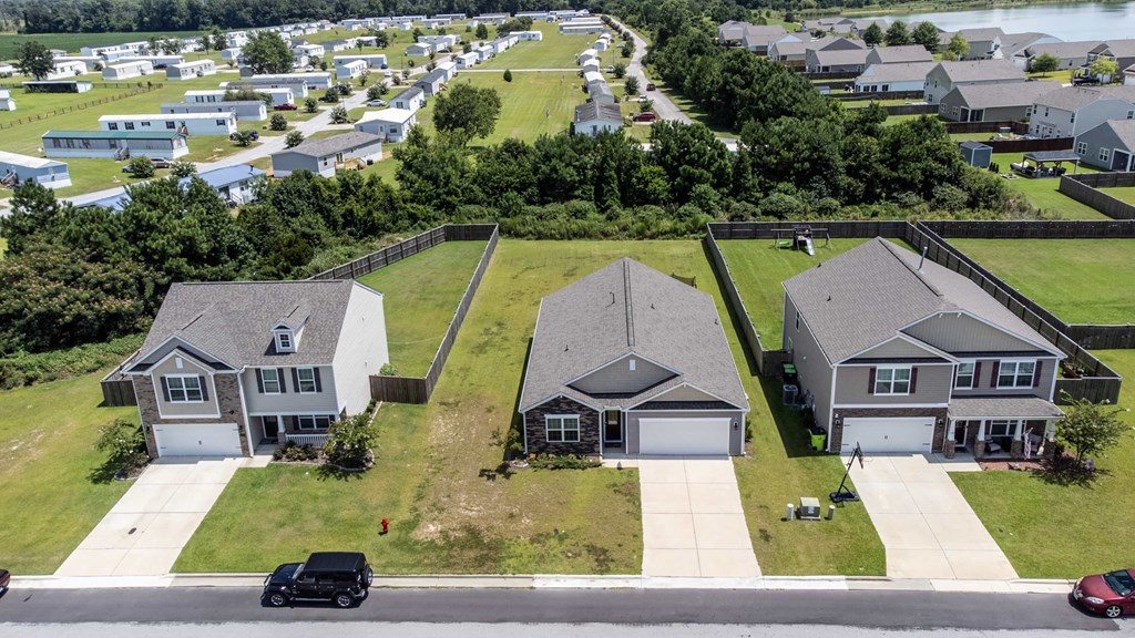 A suburban neighborhood with houses and cars parked on the street.