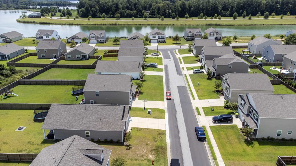 A bird's eye view of a residential neighborhood with houses and cars.