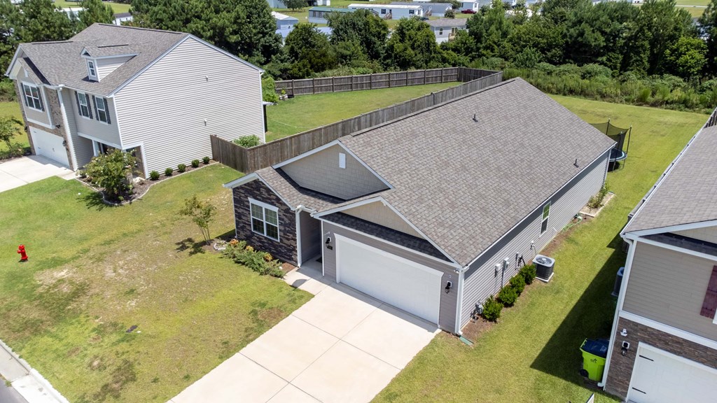 A house with a grey roof and a white garage door.