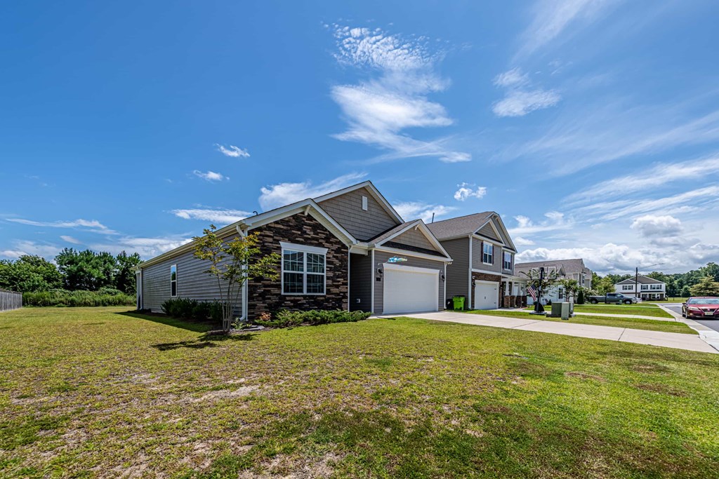 A house with a garage and a driveway is shown in the image.