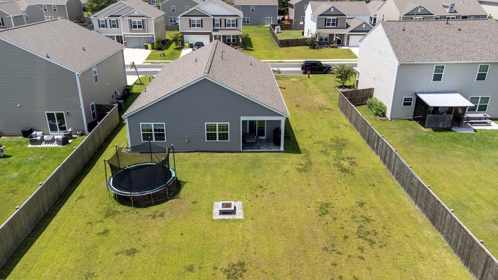 A house with a trampoline in the backyard.