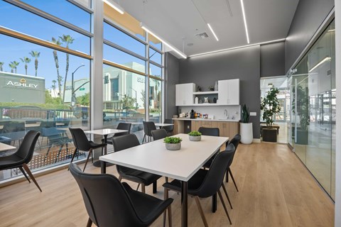 A modern conference room with a long table and chairs.