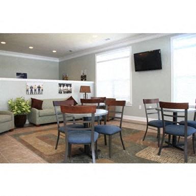 a dining room with a table and chairs