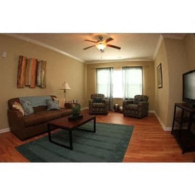 a living room with a ceiling fan
