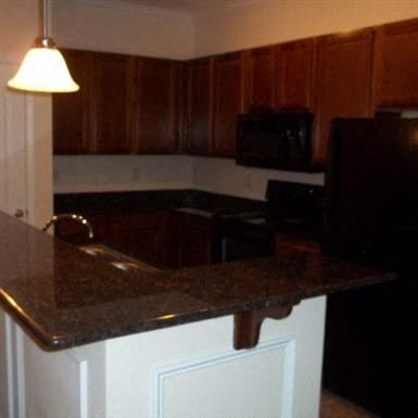 a kitchen with a granite counter top and a sink