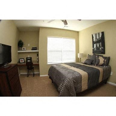 a bedroom with a bed and a tv