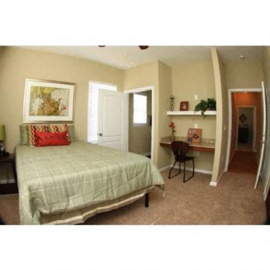 a bedroom with a bed and a desk