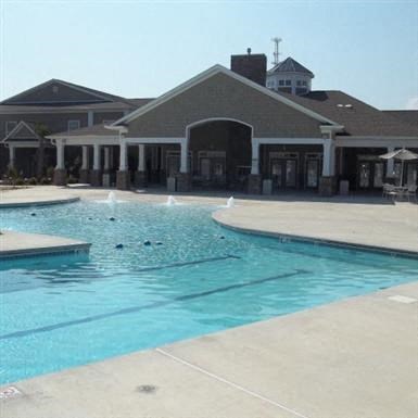 a large swimming pool in front of a building